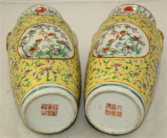 A pair of Chinese yellow ground famille rose vases, Jiaqing marks, early 20th century, 23cm